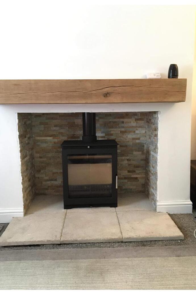 Stove with stone tile hearth and oak beam